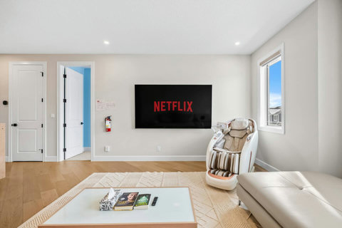 Unwind in your living room with Netflix, a massage chair and plush sofa