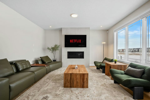 Cosy up beside the modern fireplace and catch your favourite streaming shows
