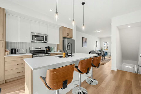 Sleek modern kitchen featuring a spacious island and stainless steel appliances.