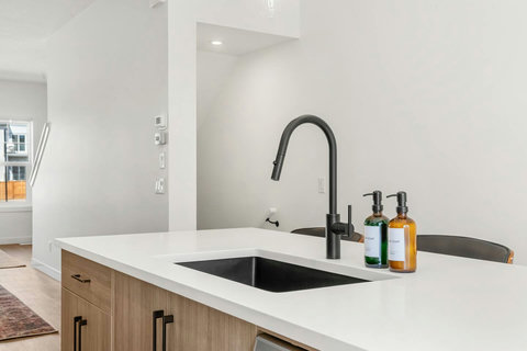 Sleek modern kitchen featuring a stunning waterfall island with premium fixtures