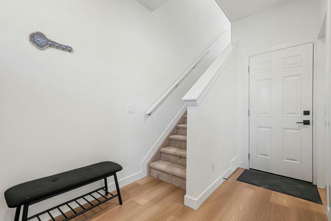 Bright, welcoming entryway with convenient closet storage and staircase access
