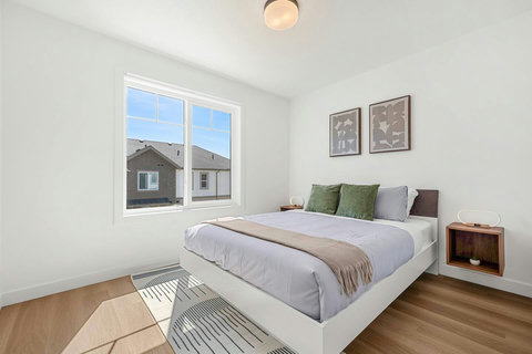 Peaceful bedroom with natural light and comfortable queen bed
