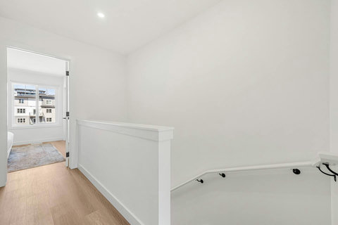 Light-filled hallway with elegant white trim and warm wood floors