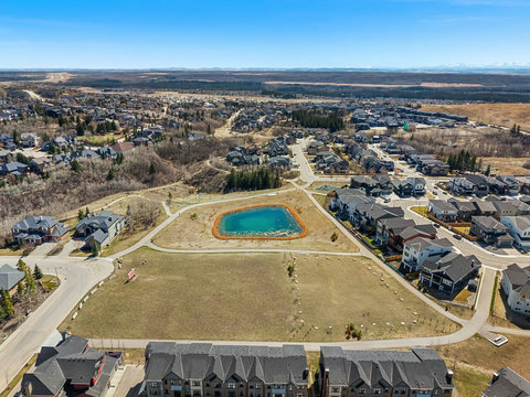 Beautiful aerial view of our vibrant community with scenic pond and landscaped grounds