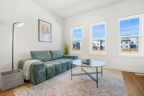 Sunny living room with comfortable seating and bright city views