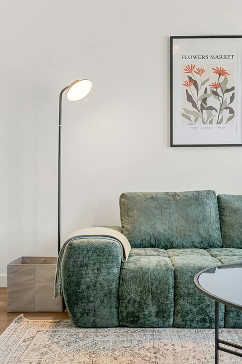 Comfortable modern living space with stylish green seating and warm lighting
