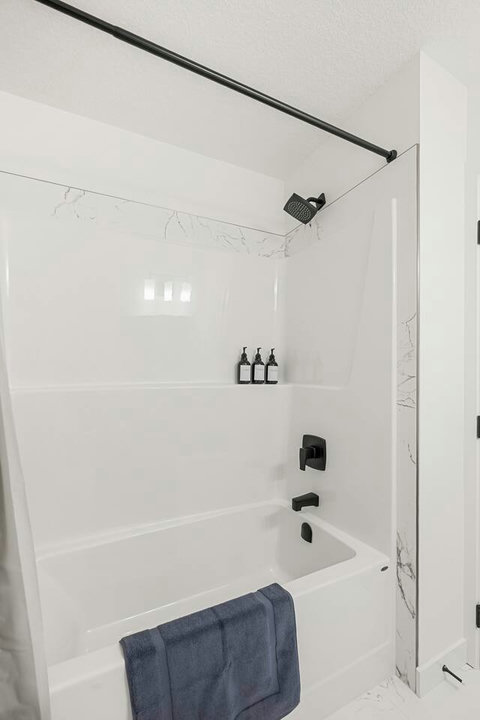 Sleek bathroom featuring a rainfall showerhead and elegant marble finishes