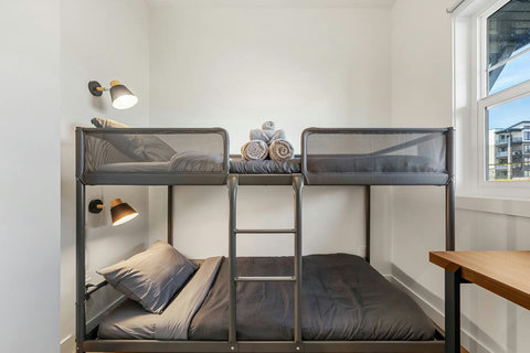 Stylish shared bedroom with sturdy bunk beds and natural light