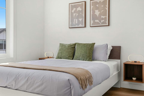 Bright, serene bedroom with tasteful decor and cozy bedding