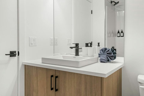 Spa-inspired bathroom with sleek vessel sink and warm wood cabinetry