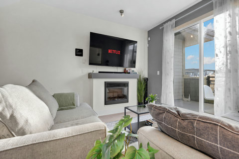 Cozy living space with fireplace, smart TV, and stunning city views
