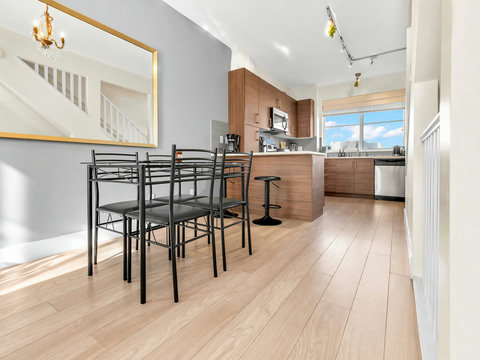 Bright modern kitchen with stainless steel appliances and breakfast bar seating