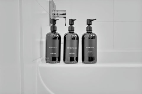 Luxe bathroom amenities with shampoo, conditioner, and body wash