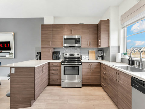Fully equipped kitchen with stainless steel appliances and ample counter space