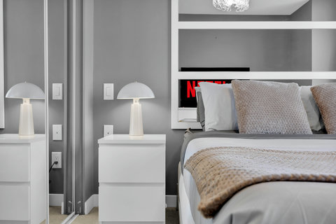 Stylish bedroom retreat with custom shelving and ambient lighting