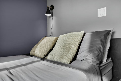 Cozy guest bedroom with modern amenities and warm lighting