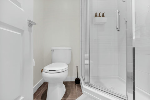 Contemporary full bathroom featuring a spacious walk-in shower with clean white finishes