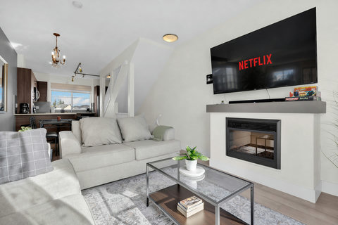 Comfortable living room with fireplace, smart TV, and mountain views