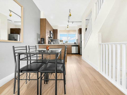 Bright open kitchen flows seamlessly into dining space with natural light