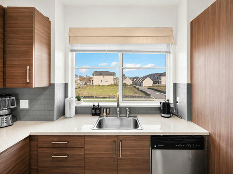 Bright modern kitchen with countryside views and stainless steel appliances