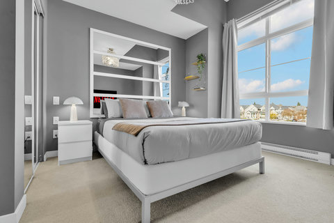 Bright master bedroom with stunning waterfront views and contemporary design