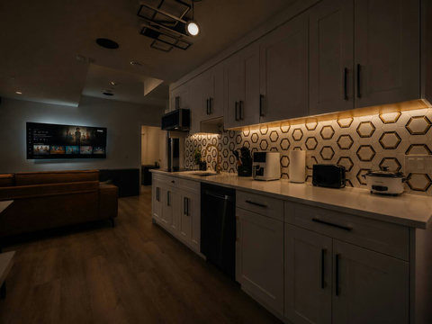Stylish kitchen featuring geometric backsplash and spacious island countertop