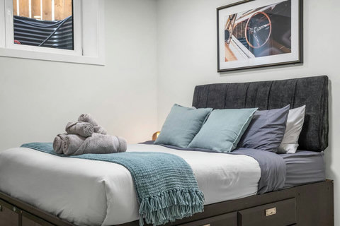 Stylish guest bedroom with comfortable bedding and thoughtful décor touches