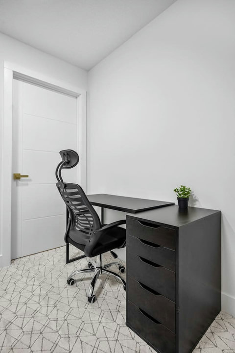 Dedicated home office space with comfortable ergonomic seating and storage