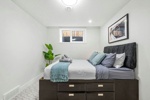 Comfortable guest bedroom with stylish platform bed and storage drawers