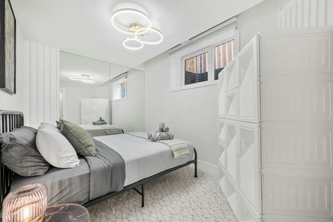 Stylish guest bedroom with modern amenities and plenty of natural light