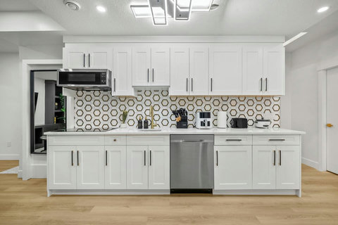 Bright, fully equipped kitchen with stylish hexagonal backsplash and modern finishes