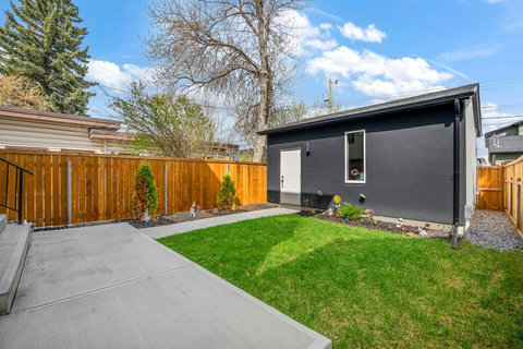 Beautiful backyard oasis with manicured lawn and modern amenities.