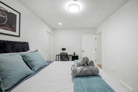 Comfortable guest bedroom with dedicated workspace and natural light