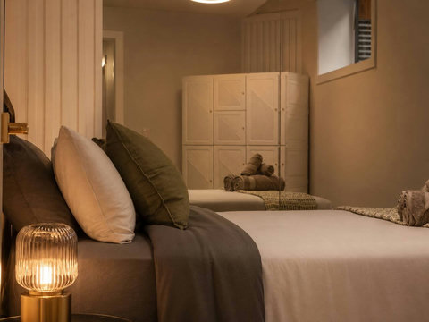 Serene guest bedroom with plush bedding, soft ambient lighting, and contemporary design