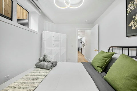 Comfortable guest bedroom with fresh green touches and contemporary style throughout
