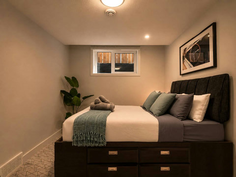 Inviting guest bedroom with plush black bed and modern amenities