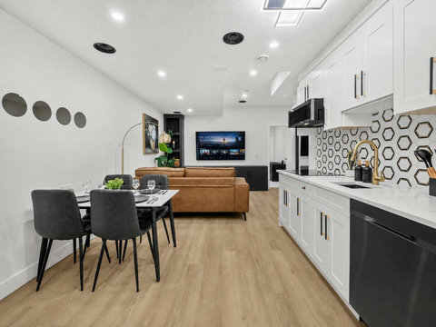 Stylish open-concept living area with contemporary kitchen and entertainment setup