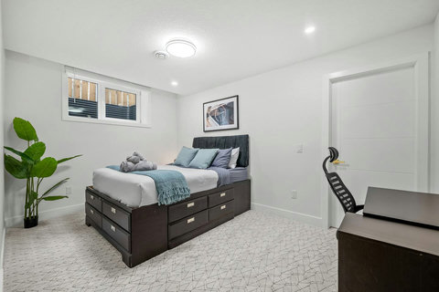 Comfortable guest bedroom with ample storage and dedicated workspace