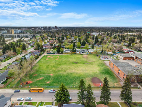 Community gathering space with expansive grounds and tree-lined residential surroundings