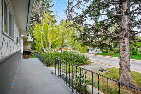 Welcome to your own peaceful front porch retreat with scenic tree-lined views