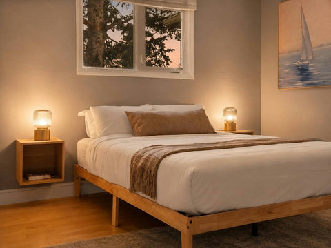 Cozy guest bedroom with serene water views and warm ambient lighting
