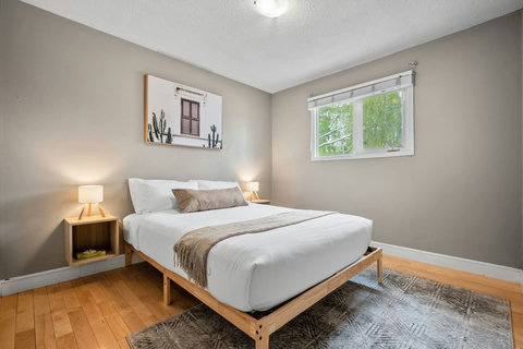 Serene guest bedroom with natural light and peaceful garden views