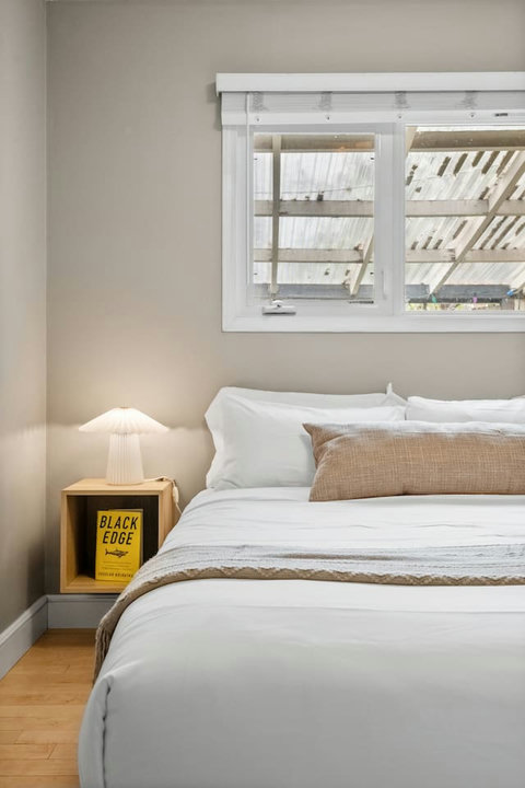 Serene guest bedroom with crisp white bedding and warm natural light