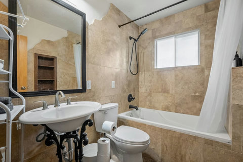 Luxurious master bath featuring travertine finishes and a relaxing soaking tub