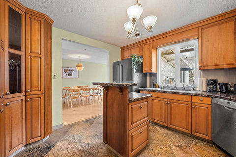 Welcoming kitchen with warm wood cabinetry and modern appliances