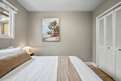 Serene guest bedroom featuring warm neutral tones and peaceful coastal decor