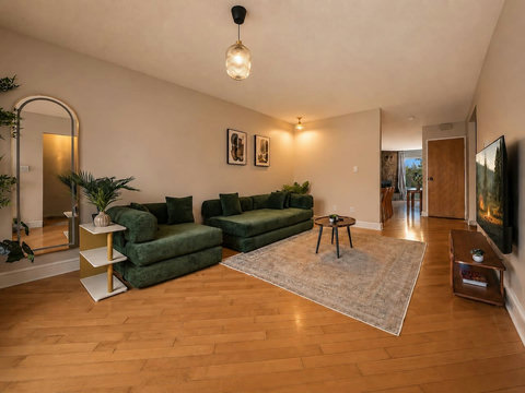 Comfortable living room with modern green sectional and warm ambiance throughout
