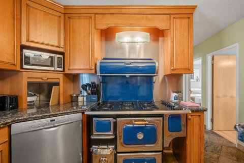 Fully equipped chef's kitchen featuring a stunning blue vintage range.