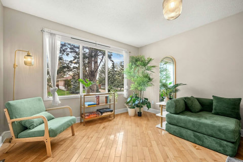 Airy living room with comfortable seating and garden views throughout