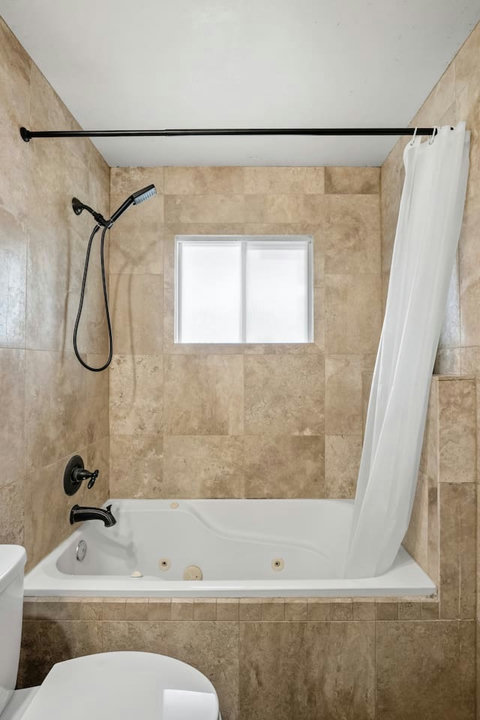 Luxurious spa-like bathroom with deep soaking tub and rainfall showerhead
